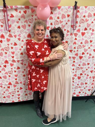 Tammy Veasley (right), the senior center's assistant director, thanks Debbie Winsett for being the DJ at the Valentine's Ball on Tuesday. Veasley helped Winsett teach line dances to the guests. (Photo/Shelby Wingate)