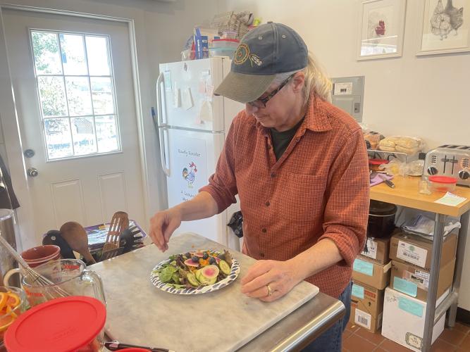 Jamie Lewis prepares one of her many salads served at the Rowdy Rooster. Some of the ingredients come straight from Lewis' garden back home. (RAMON ELORTONDO/OGLETHORPE ECHO)