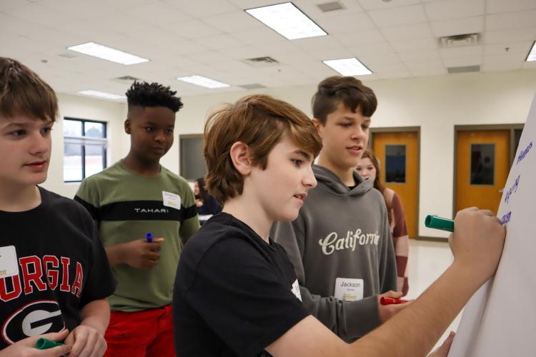 At Oglethorpe County Middle School on Feb. 9 the students of the Youth Leadership course work together to identify the components of a conflict. Students Brodie Layne, Jackson Boone, Amarion Alexanders and Jack Baldwin brainstormed together during a class activity of describing conflict. (Photo/ Viktoria Kangas)