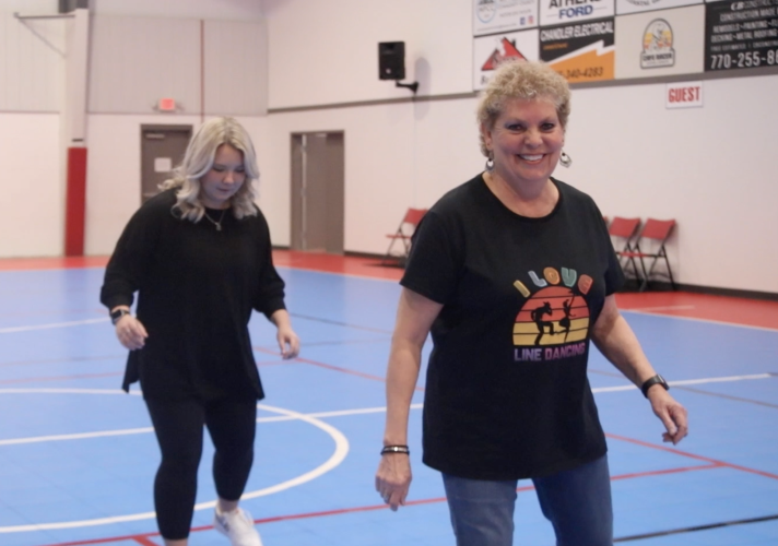 OLIVIA SHAPIRO/THE OGLETHORPE ECHO After teaching the steps to the line dance, One Step Forward, Two Steps Back, instructor Debbie Winsett puts music behind the moves.