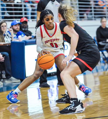 CHARLES JORDAN/FOR THE OGLETHORPE ECHO Denim Goddard dribbles against a Rabun County defender in the Class A Division I tournament. She was the Region 5-A Division I player of the year and led the Lady Patriots to a 20-9 record.