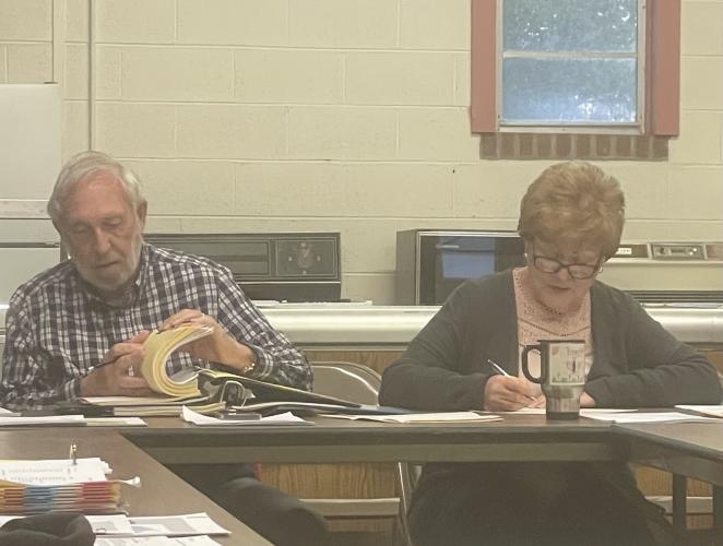 Maxeys Mayor Warren Gilson sits next to clerk Sherry Gilson as the city council discusses slowing traffic through town and other business in its meeting on March 14.