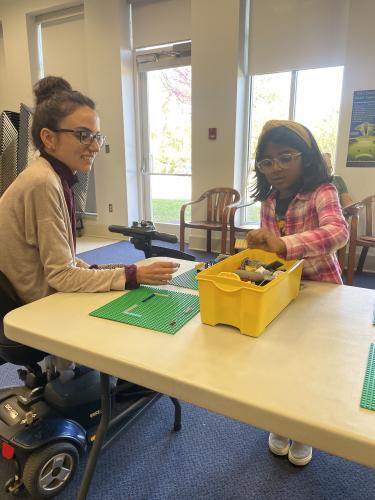 Jessica Ellis (left), who works at the Oglethorpe County Library, and Emma Hernandez (right) chat while Hernandez builds the beginning stages of a treehouse. The library hosts the Lego Club once a month. (RAMON ELORTONDO/THE OGLETHORPE ECHO)