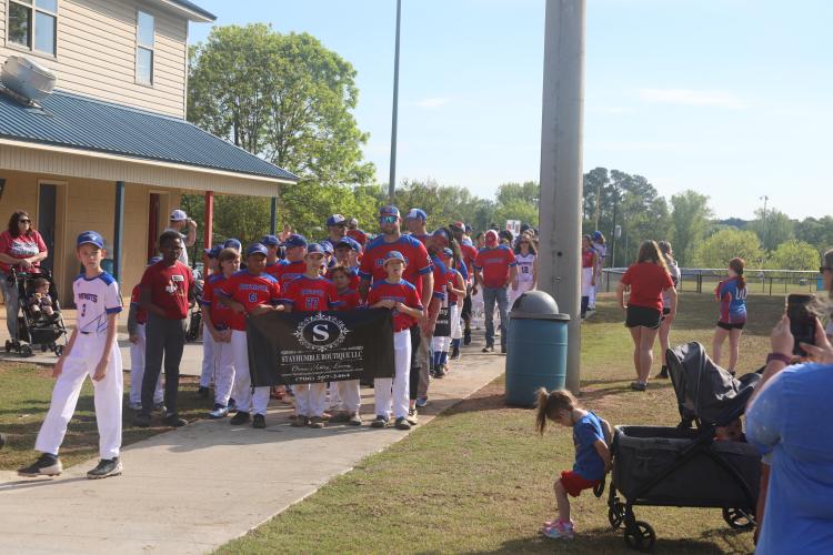 (JACK RHODES/THE OGLETHORPE ECHO) Little league teams kick off the parade as they walk together holding up signs from their sponsors. The sponsor consisted of local businesses and each team had a specific sponsor assigned to them.