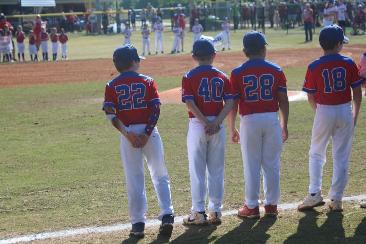 (JACK RHODES/THE OGLETHORPE ECHO) Brian Buck (#28), Trey Gabriel (#40) and Griffin Foster (#22) line up as they get honored as part of the previous little league all-star team. This was a part of the opening ceremony that kicked off a full day of baseball and softball