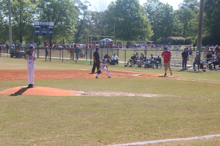 (JACK RHODES/THE OGLETHORPE ECHO) Coleman Rogers winds up to throw the first pitch of the opening little league boys 10 under game. It was a great day for baseball with the sun out and the temperature being in the 70s for the first games.