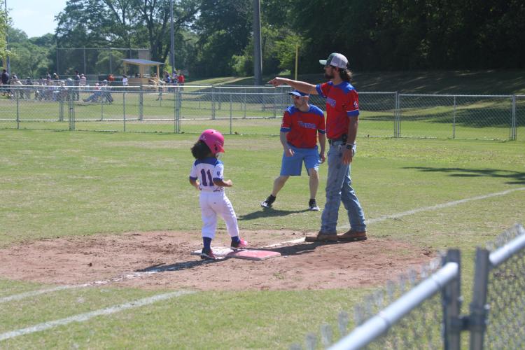 (JACK RHODES/THE OGLETHORPE ECHO) Nola Fleming (#11) stops at first after hitting a ball off of a coach's pitch. She played on one of the 7-8 year old teams that consisted of both girls and boys.