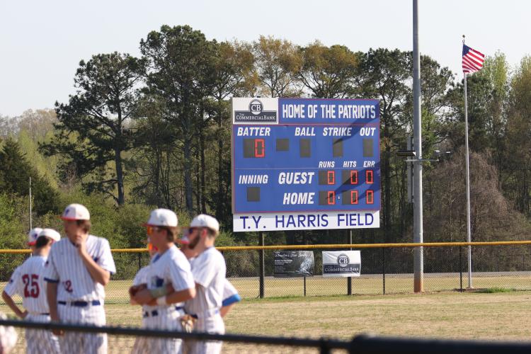 The Oglethorpe County baseball team prepares for its game on Friday, after the field was named for TY Harris, the former school superintendent. (Emily Dozier/The Oglethorpe Echo)