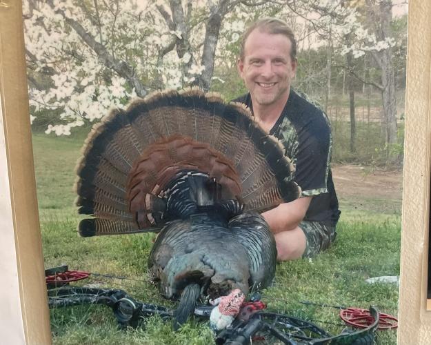 (Alex Bavosa/The Oglethorpe Echo) Andy Nimmons has a photo of himself posing with a turkey he hunted with a bow at his shop, Andy Nimmons Taxidermy, which is in Lexington.