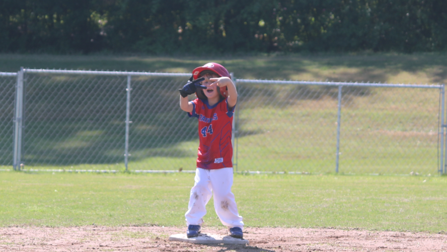 (JACK RHODES/THE OGLETHORPE ECHO) Everet Boss celebrates after sliding into second base in the little league coach pitch game. The game consisted of 7-8 year old boys and girls on the same team, along with a mix of parents who took turns pitching to their children.