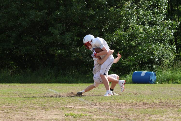 Collin Pruitt (13) tackles Caden Hartrum (22) at spring practice last week. Mike Holland enters his third season as the head coach of the Patriots. (LANDEN TODD/THE OGLETHORPE ECHO)