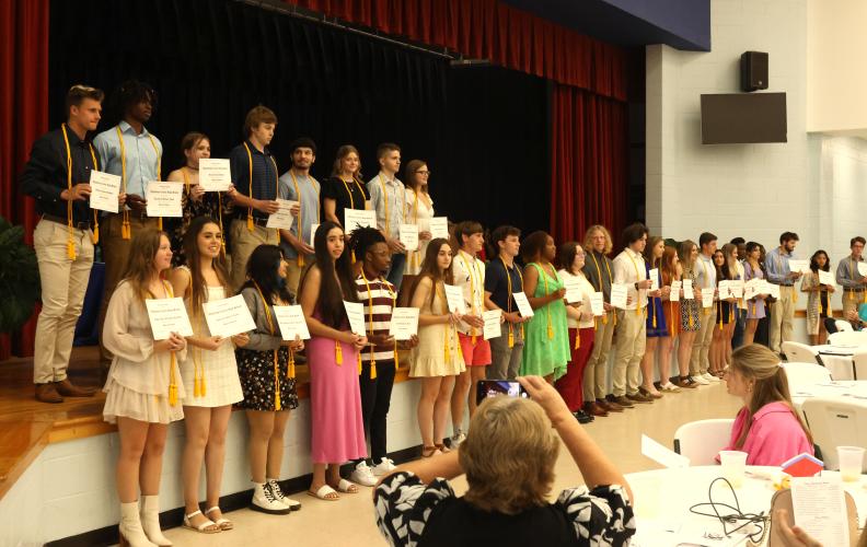 A group of seniors receives the OCHS honor award at the Class of 2023 Senior Honors Night at the cafeteria on Tuesday. The award recognizes students with an overall GPA of 90 or above and who hasn’t failed a class for four years of high school. (LANDEN TODD/THE OGLETHORPE ECHO)