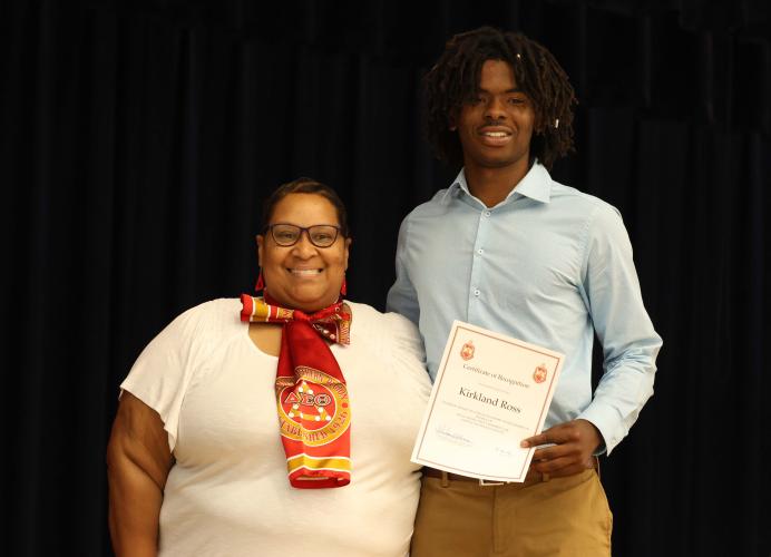 Shatana Williams, representing the Athens Alumnae Chapter of Delta Sigma Theta Sorority, awards OCHS senior Kirkland Ross with an academic scholarship on Tuesday. (LANDEN TODD/THE OGLETHORPE ECHO)