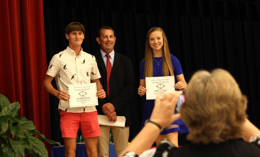 Oglethorpe County High School seniors Luke McGarity (left) and Harley Grace Hayes (right) receive the Herman and Magdalene Hicks Award from incoming principal Bill Sampson (center). (LANDEN TODD/THE OGLETHORPE ECHO)
