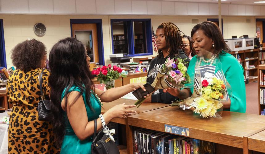 Kristolyn Long (from left), Nikki Johnson and Jordan Johnson bring flowers to show support for OCHS principal Susie Johnson, who is retiring this year. Johnson said she already has a trip planned for Costa Rica. (LANDEN TODD/THE OGLETHORPE ECHO)