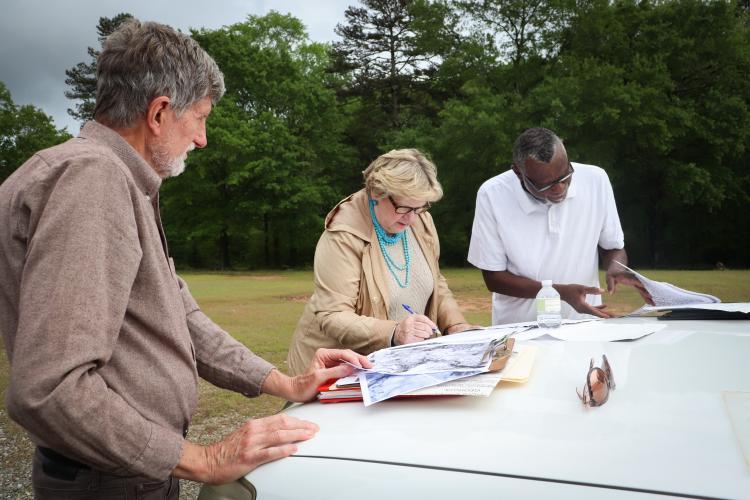 Tom Gresham (from left), Ashley Simpson and Joe Baughns look over historical documents about St. John AME Church and Springfield Church in Crawford last month while working on the Digital Atlas Project. (MADDIE DANIEL/THE OGLETHORPE ECHO)