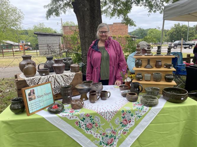 Mary Mayes is a pottery maker from Oglethorpe County. "I use Georgia red clay to make my pieces. I can do different kinds of designs using granite, marble, ochre or ash and traditional slips. I try to make simple but timeless pieces." She was among several vendors who set up at the Art Bazaar and Book Sale on Saturday.(RAMON ELORTONDO/THE OGLETHORPE ECHO)