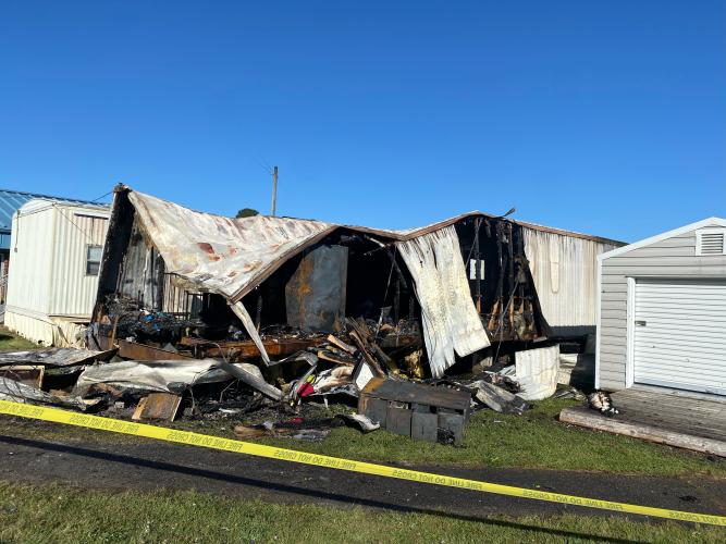 Caution tape surrounds the remains of a storage trailer that burned at Oglethorpe County Elementary School on Monday morning. The trailer contained paper and decorations for themed celebrations. (DINK NESMITH/THE OGLETHORPE ECHO)