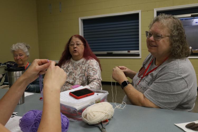Virginia Sanders, far right, crochets as she engages in conversation with others at a Covered with Love meeting in March at Lexington Baptist Church. The members, who create and donate afghans, have been meeting for seven years, and this year, they are donating their work to Quiet Oaks Health Care Center. (ELIZABETH RYMAREV/FOR THE OGLETHORPE ECHO)