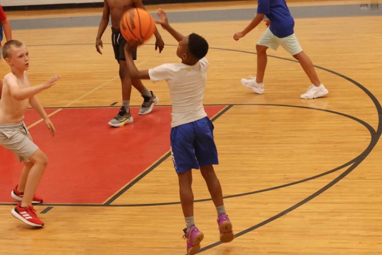 Camper De’Kobe Williams shoots a jumper over the defense during the session-ending 5-on-5 scrimmage at the OCHS gym. (LANDEN TODD/THE OGLETHORPE ECHO)