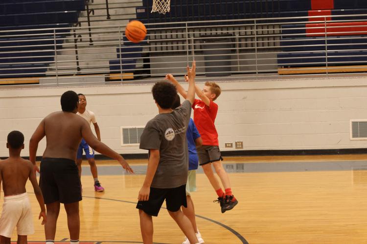 Camper Grayson Graham tests his long-range skills with a 3-point attempt during the 5-on-5 scrimmage portion of the basketball camp at OCHS. (LANDEN TODD/THE OGLETHORPE ECHO)