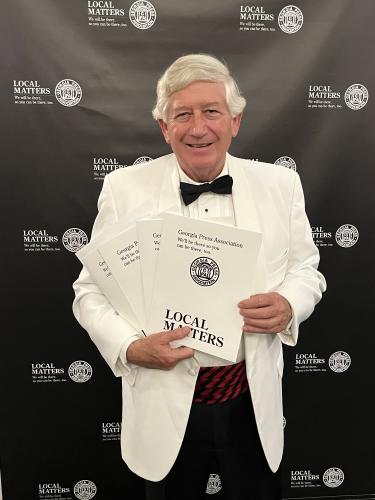 Dink NeSmith, chairman of The Oglethorpe Echo Legacy, Inc., holds the awards that were given to The Oglethorpe Echo at the an- nual GPA Convention on June 9. (SUBMITTED PHOTO)