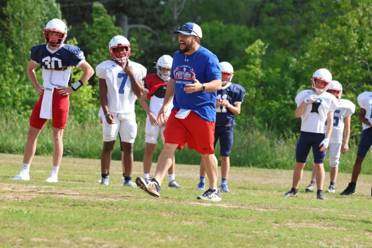 Head football coach Mike Holland encourages his players during spring practice last month. Holland will share AD duties with Brianna Dickens. (LANDEN TODD/THE OGLETHORPE ECHO)