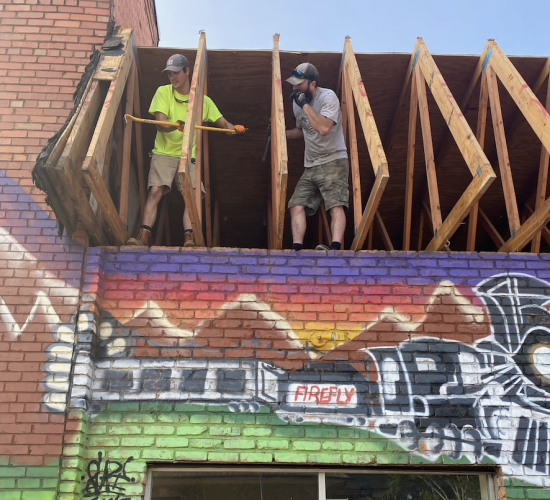 Ethan Allen (left) and Jake Fields work on buildings in downtown Crawford in preparation for opening of Crawford Pizza, a restaurant owned by Noah Shealy and Blake Arnold. (DINK NESMITH/THE OGLETHORPE ECHO)