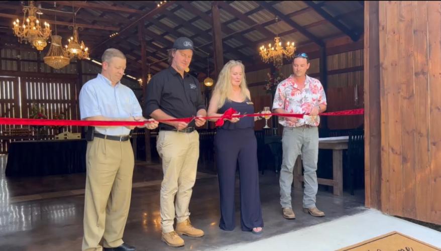 Oglethorpe County Commissioner Tracy Norman (from left), owners Blake and Shannon Bailey, and Crawford Mayor Seavy O’Neal prepare to officially open The Grove at Bailey Farms last Saturday. The new venue is on the site of the former Nix farm, which was owned by Aubrey Nix, who died in 1989. (SUBMITTED PHOTO)