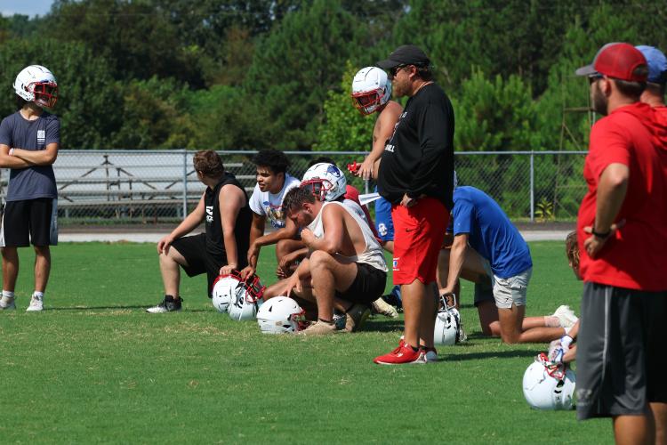 Oglethorpe County football players and coaches watch the action from the sidelines during practice on Monday morning. (LANDEN TODD/THE OGLETHORPE ECHO)