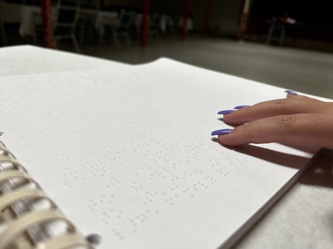 Fingers read Braille on a page. Debbie Winsett is a local translator and teacher, but there’s a shortage of people in the profession at the national level. (MOLLY LINDER/THE OGLETHORPE ECHO)
