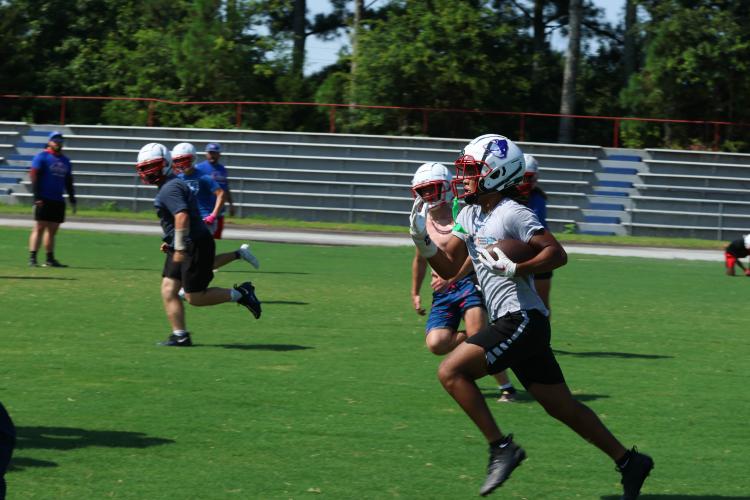 Jordan Johnson runs past defenders during Oglethorpe County football practice on Monday. The Patriots host West Hall in a scrimmage on Aug. 11 and will open the season at East Jackson on Aug. 18. (LANDEN TODD/THE OGLETHORPE ECHO)