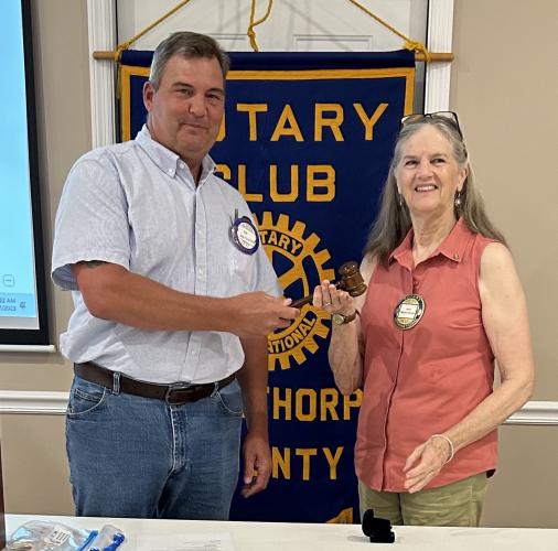 Joe Holtzleiter, the outgoing Rotary Club president, hands the gavel to new club president Jean Westmacott earlier this summer. (SUBMITTED PHOTO)