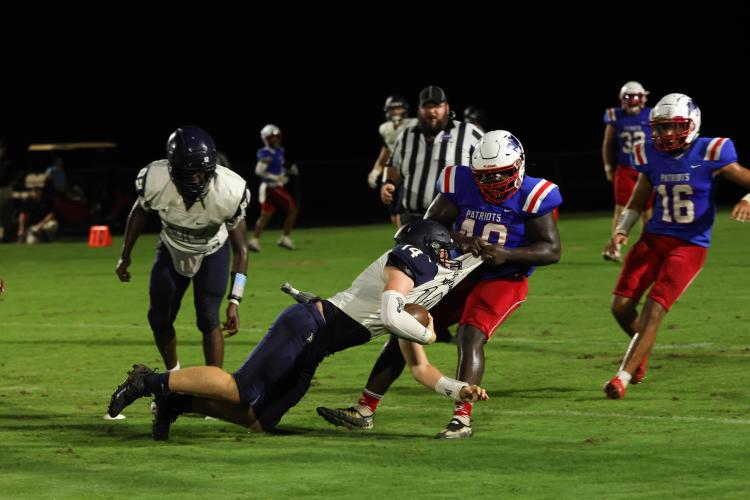 Senior Zanayain Hawkins, the only returning starter on the defensive line, pulls down a West Hall player on Friday. The Patriots have switched to a 3-3-5 defense this year to take advantage of their personnel. (LANDEN TODD/THE OGLETHORPE ECHO)