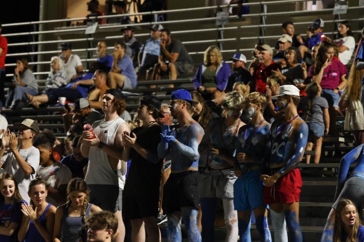OCHS fans, some painted with blue body paint, cheer on the Pa- triots in Friday’s 19-7 scrimmage win over West Wall. OCHS opens the regular season at East Jackson at 7:30 p.m. Friday. (LANDEN TODD/THE OGLETHORPE ECHO)