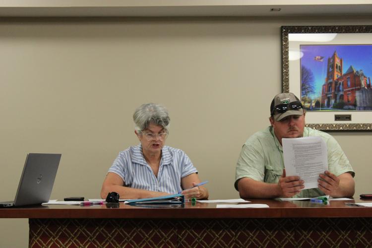 (CAITLIN DOWNING/THE OGLETHORPE ECHO) Zoning Board Chair Janet Hill and board member JF Hansford review the amended ordinance on solar farms at the zoning board meeting on Monday.