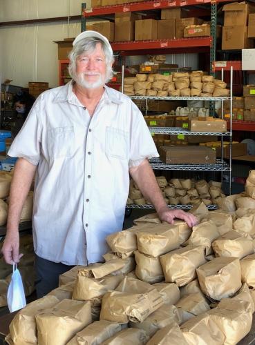 Tommy Carter in his lab with bags of soybeans he developed just before he retired from North Carolina State in 2019. Carter’s family has roots in Oglethorpe County dating to the 1800s. (SUBMITTED PHOTO)