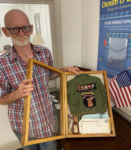 James Bennett, who owns Lost &amp; Found Antiques and Collectibles in Lexington, filled a shadowbox with the custom military jacket and letters from a soldier in Vietnam that he found while cleaning out an old house. Lexington resident Jennifer Whitlock helped return the items to the Vinson family. (DINK NESMITH/THE OGLETHORPE ECHO)