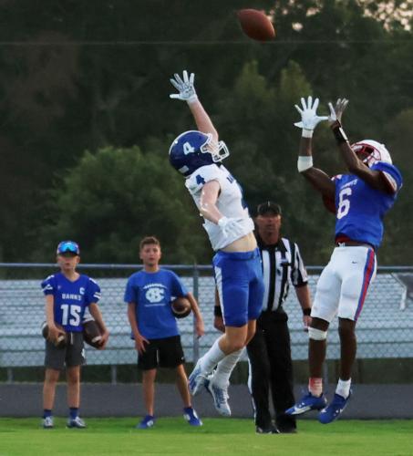 Oglethorpe County’s Darius Heard leaps to pull in a 13-yard touchdown pass over Banks County’s Caden Watson for the Patriots’ first touchdown in their 19-14 loss to Banks County in Lexington on Friday night. (NOOR ABDALLAH/THE OGLETHORPE ECHO)