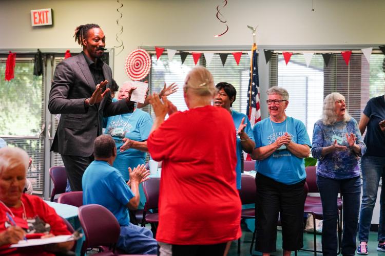 NBA All Star Dwight Howard recieves applause from Shirley Kidd, Jenny Wynne, and other senior center members as he enters on Friday morning, Sept. 15, 2023. Howard hosted 'Family Feud' at the Oglethorpe Senior Center in Crawford, Georgia. (Photo/Sidney Chansamone)
