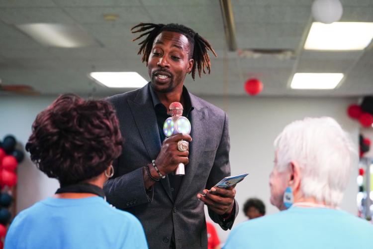NBA All Star Dwight Howard reads off questions to the blue team on Friday morning, Sept. 15, 2023. Howard hosted 'Family Feud' at the Oglethorpe Senior Center in Crawford, Georgia. (Photo/Sidney Chansamone)