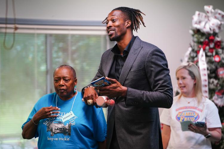 NBA All Star Dwight Howard leans on Janice Brown on Friday morning, Sept. 15, 2023. Howard hosted 'Family Feud' at the Oglethorpe Senior Center in Crawford, Georgia. (Photo/Sidney Chansamone)