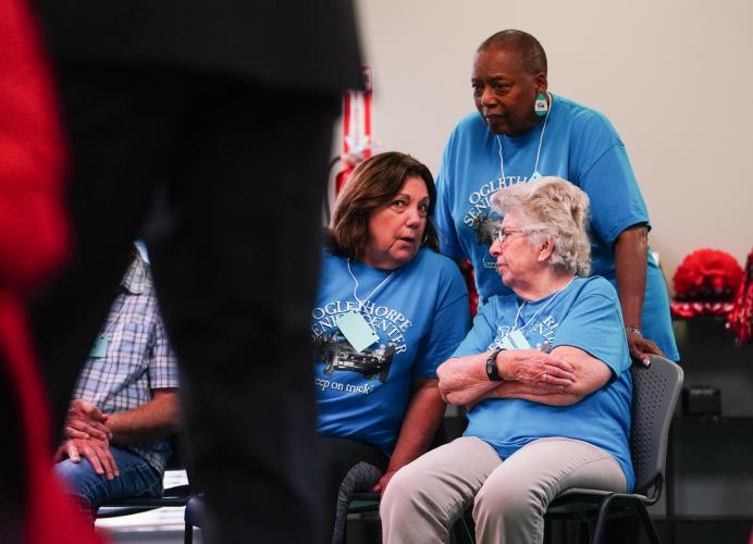 Blue team players Marlene Cardlin, Janice Brown and Willodean Wright plan their answers during the red team's turn on Friday morning, Sept. 15, 2023. NBA All Star Dwight Howard hosted 'Family Feud' at the Oglethorpe Senior Center in Crawford, Georgia. (Photo/Sidney Chansamone)