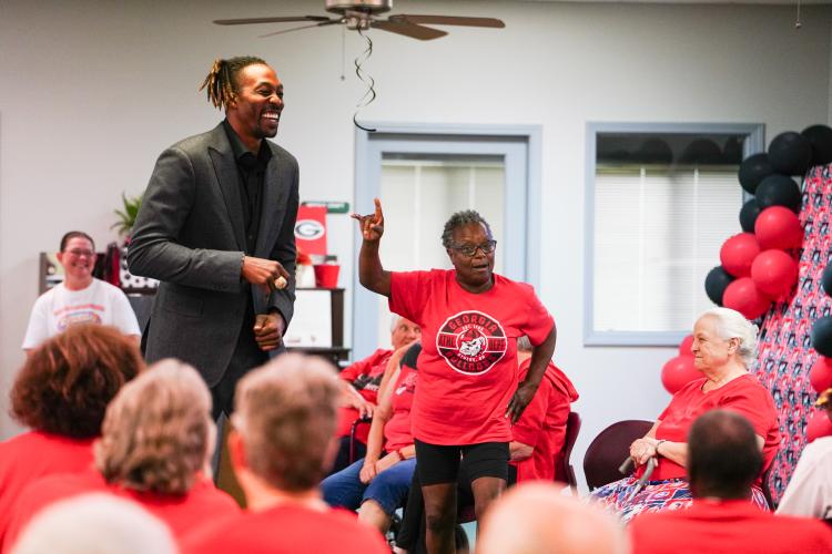 Emma Hunt and NBA All Star Dwight Howard dance together on Friday morning, Sept. 15, 2023. Howard hosted 'Family Feud' at the Oglethorpe Senior Center in Crawford, Georgia. (Photo/Sidney Chansamone)