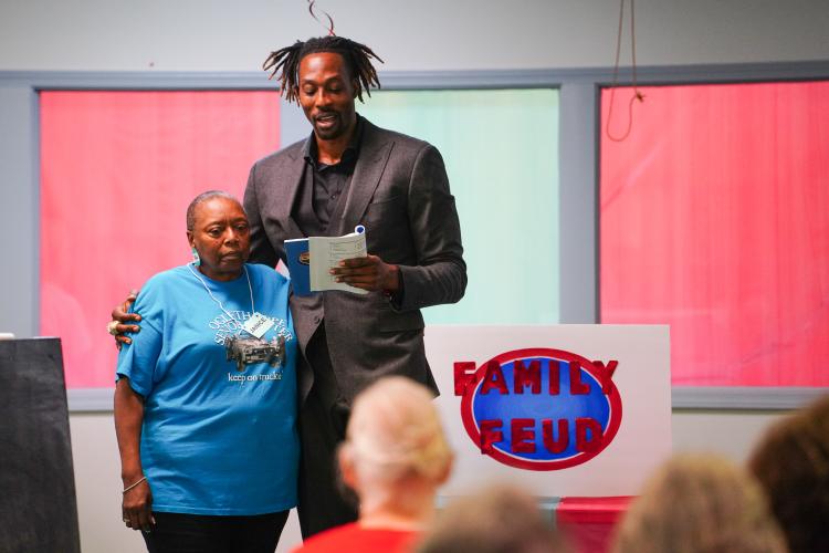 NBA All Star Dwight Howard questions Janice Brown during the final round of the game on Friday morning, Sept. 15, 2023. Howard hosted 'Family Feud' at the Oglethorpe Senior Center in Crawford, Georgia. (Photo/Sidney Chansamone)