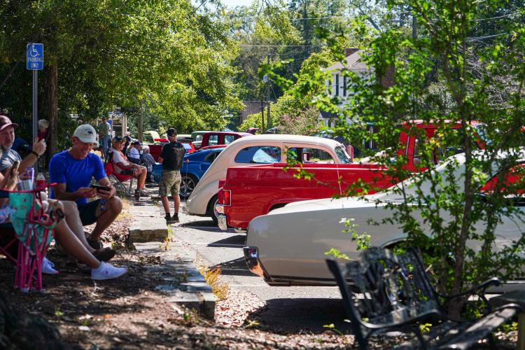 Owners of vintage cars sit alongside their vehicles at the Firefly Cruise In. Eleven plaques were given out to the vehicles with the highest quality and condition. (Sidney Chansamone/The Oglethorpe Echo)
