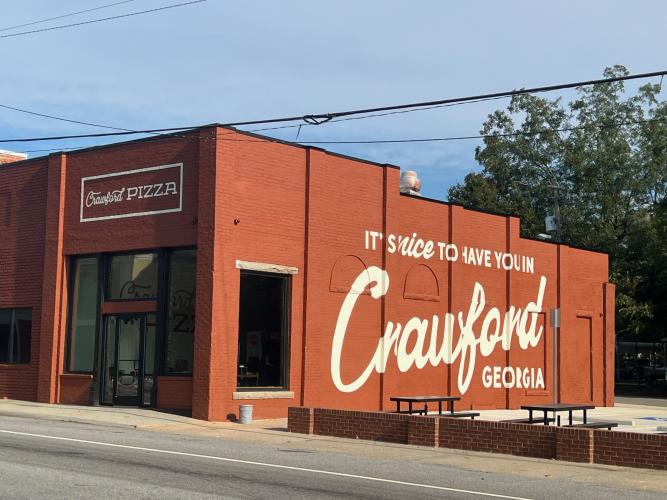 Crawford Pizza sits on Athens Rd. in Downtown Crawford. Customers are able to place a to-go order, eat inside, or sit at the picnic tables outside. (Jordan Long/The Oglethorpe Echo)