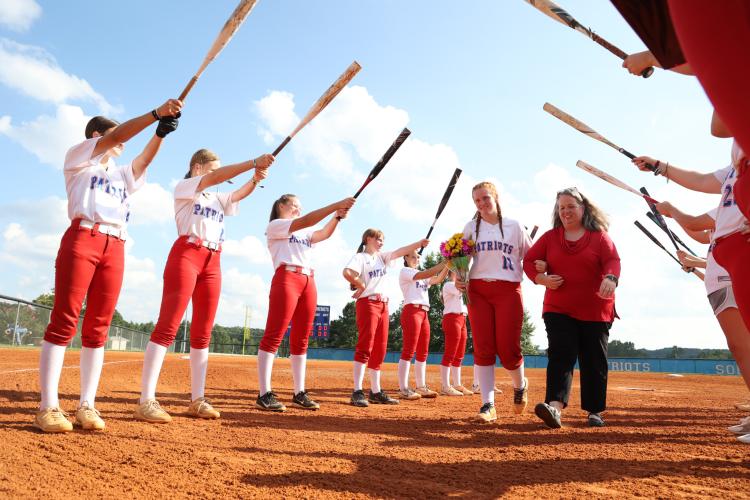 Senior catcher Abby Jones and her mom, Stephanie Jones, walk between rows of her Oglethorpe County teammates during the Senior Night celebration prior to the Patriots’ game against Washington-Wilkes on Aug. 31. Jones is the only senior on this year’s team. CASSIDY HETTESHEIMER/THE OGLETHORPE ECHO