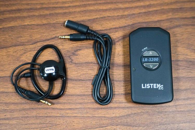 Receivers, lanyards and speakers are components of the Listen EVERYWHERE receivers that are available at the Oglethorpe County Library. The library’s staff is available to assist visitors with the new technology. (Sidney Chansamone/The Oglethorpe Echo)