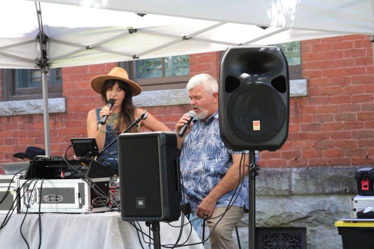 Oglethorpe County photographer Suzy VanDyke sings karaoke alongside DJ Ken Mobley at LexFest on Saturday. VanDyke, who shoots weddings and portraits with her husband, Lukas VanDyke, recently moved to Stephens. (Photo/Elena Acosta)